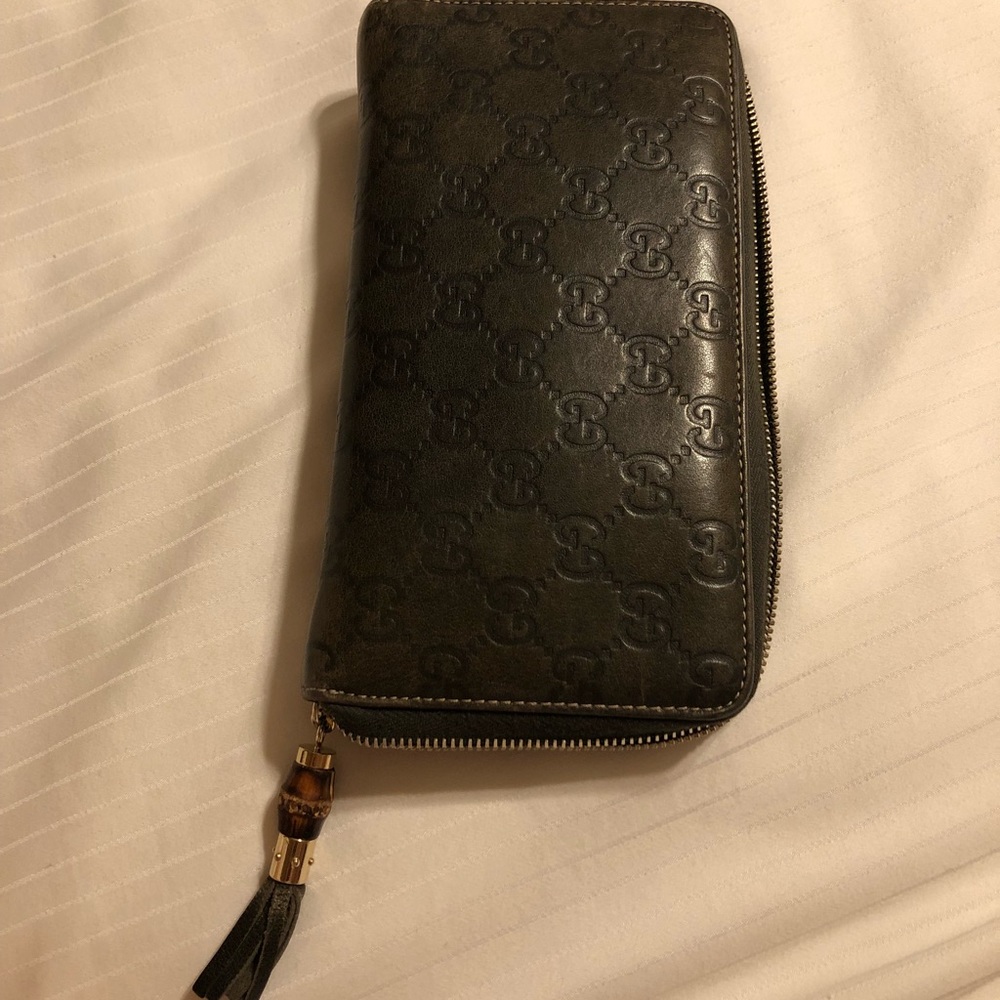 Forest green bamboo zip around Gucci wallet.